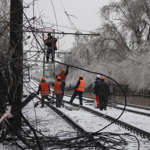 Power workers repair power lines in Ukraine in the snow.