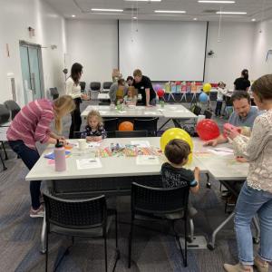 adults and children participating in science experiments and activities