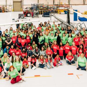 aerial view of large group of people inside a hangar