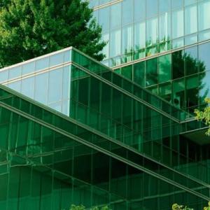 A glass building surrounded by trees
