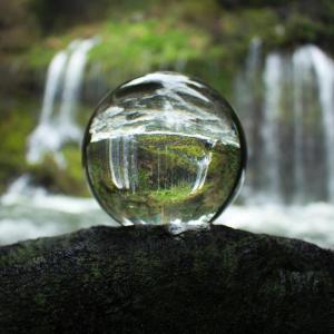 glass ball reflecting waterfall