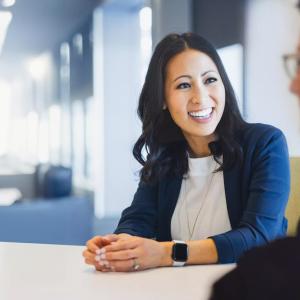 Two employees seated at a table chatting.