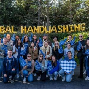 Group in front of Global Handwashing Day letter balloons