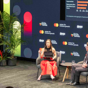two people on stage during the Global Inclusive Growth Summit