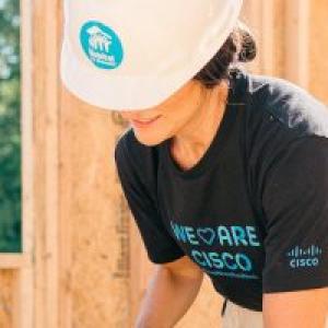 person wearing a hard hat building a structure