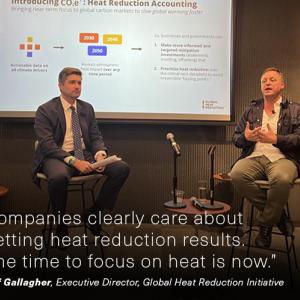 Two people giving presentation in front of screen