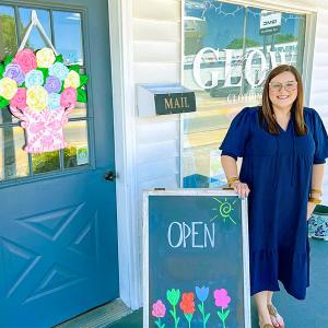 A person stood outside a boutique shop 