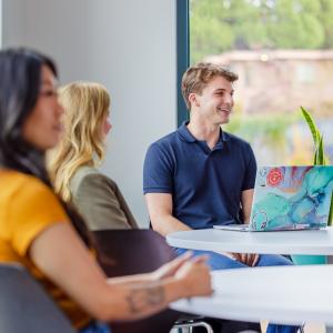 Three people seated around a table.