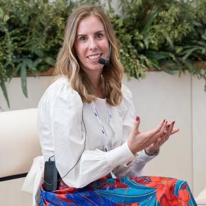 Selina Biebet seated in a garden.