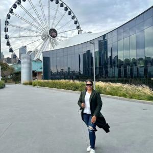Shazia shown in front of a ferris wheel.