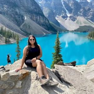 Shaiza shown on top of a mountain overlooking a lake.