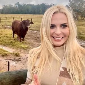 Mel Saettone on a farm with a cow in the background.