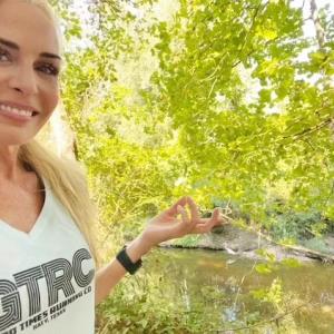 Mel Saettone hiking in a wetland area.