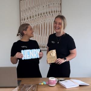 Ellie and Elyssa holding a sign.