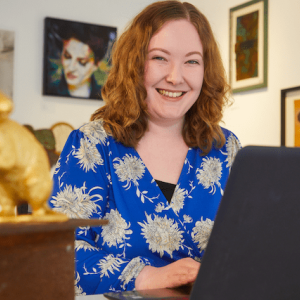 BobCat Gallery owner Catherine Sweet behind a laptop.