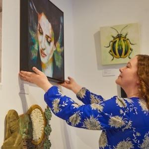 Catherine admiring a painting.A bit of tidying up in the gallery.