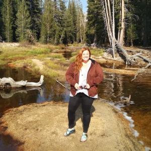 Teddy Nixon at the edge of a forest.