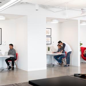 GoDaddy employees working in small groups.