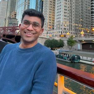 Adiyta Vikram in front of a river with a city in the background.