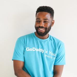 GoDaddy Employee wearing a t-shirt.