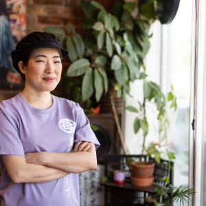 Mia Oi with arms crossed.