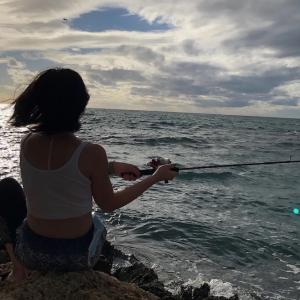 Katy Cooperstein fishing on the sea.
