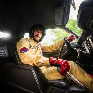 Walter behind the wheel of a race car.