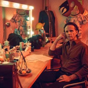 Walter Goggins seated at a dressing table.