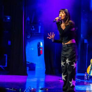 Alex Porat singing on stage