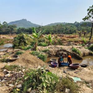 Two people pan for gold outside in Bolaneh, Sierra Leone