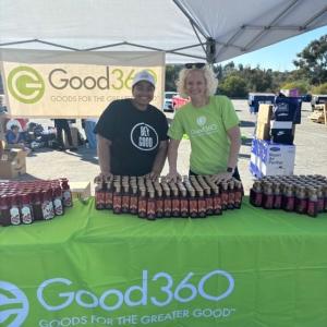 Two people standing at the Good360 booth