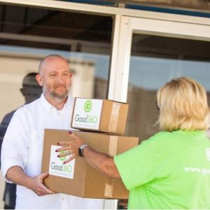 Volunteer handing off boxes