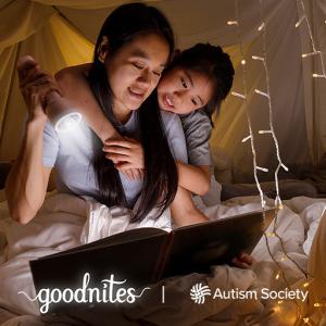 two people looking at a book in a tent
