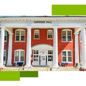 Outside front view of Governor Morehead school, two-story red brick building with white pillars supporting an overhang above the front doors.