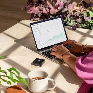 Woman seated at a desk with a laptop.