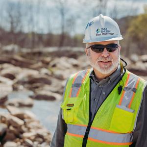 Tim Huffman wearing a high vis vest and safety helmet  