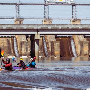 3 people kayaking in the river