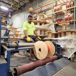 Wesco employee cutting wire.