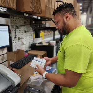 Wesco employee packing items for shipment.