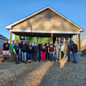Wesco employees shown in front of a Veterans Habitat for Humanity home.