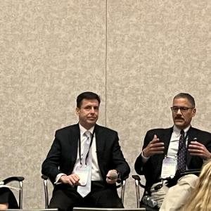 Four people sat in front of an audience at GreenFin 23