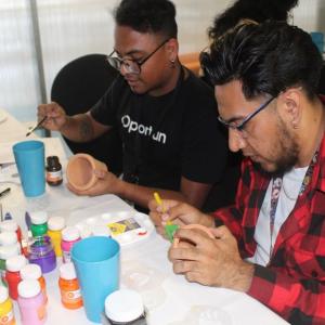 people painting items together at a table