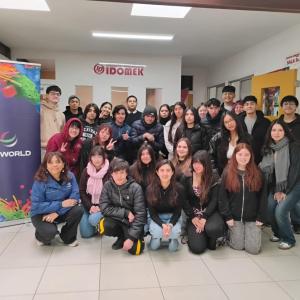 Students and programme representatives gather for a group photo beside a DP World banner in San Antonio, Chile.