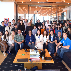 A large group photo of people in an office