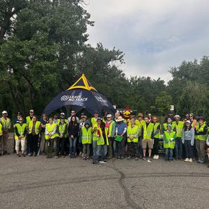 A large group of people wearing hi-vis vests 