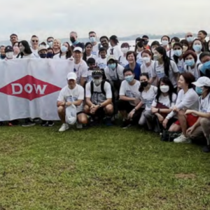 photo of a large group of people and people holding the dow logo 