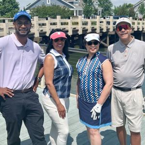 Four people stood together outdoors 