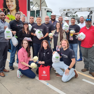 Large group of people holding food donation bags