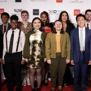 A group photo taken on a red carpet 