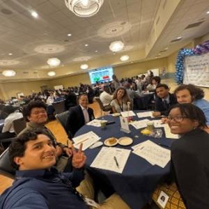 A group selfie taken around a table 